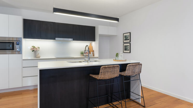 kitchen with island illuminated by LED fixture